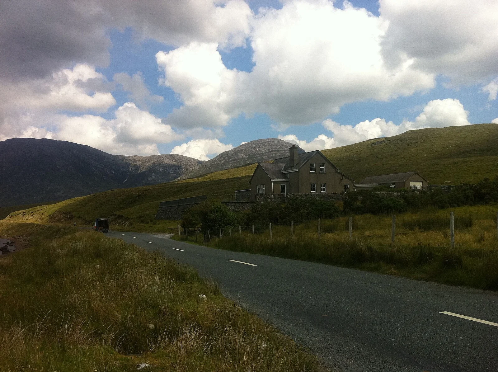 A rural road approaching hills near Leenaun